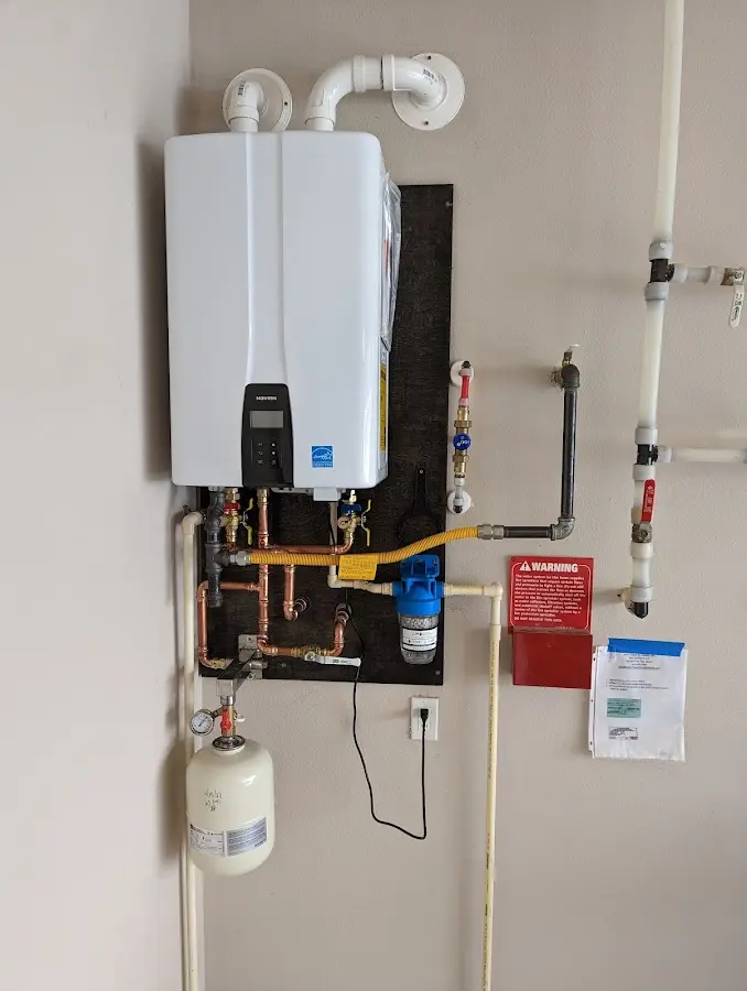 Professional plumber installing copper piping in a Litchfield Park home